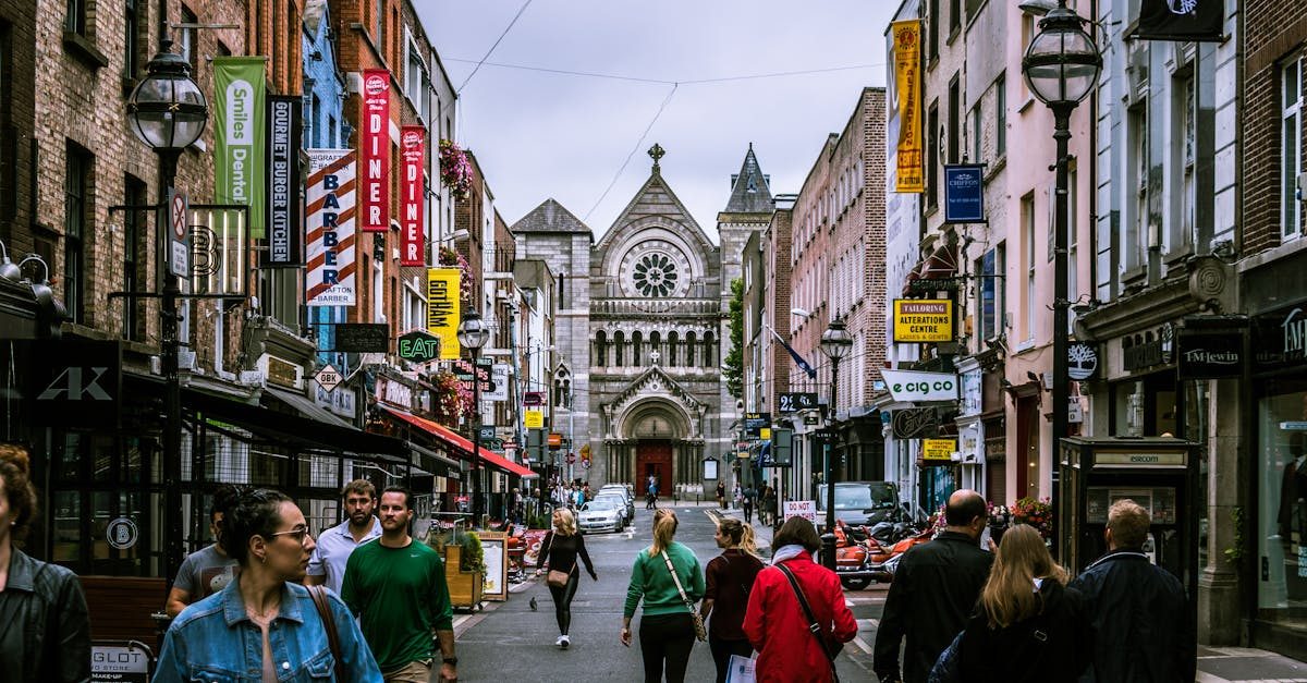 A bustling street scene in Dublin, showcasing diverse people and historic architecture.