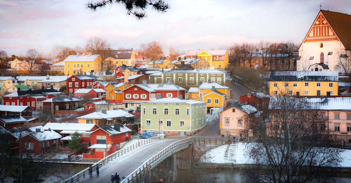 Captivating winter scene of colorful houses in Porvoo, Finland viewed from a bridge.