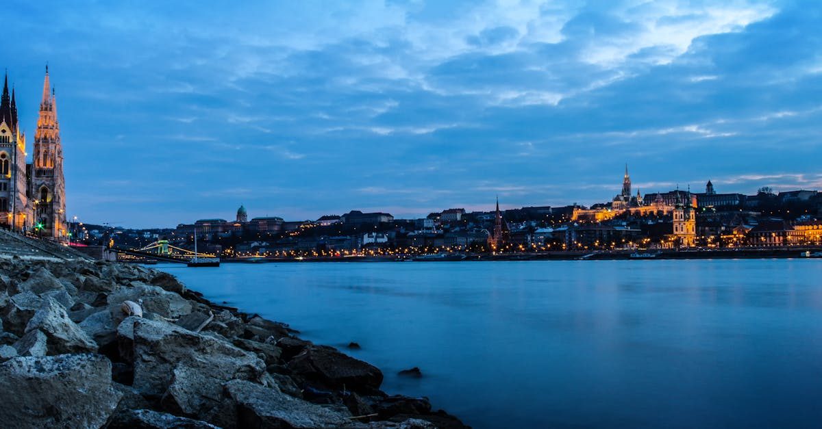 Scenic view of Budapest Parliament and Danube River at dusk.